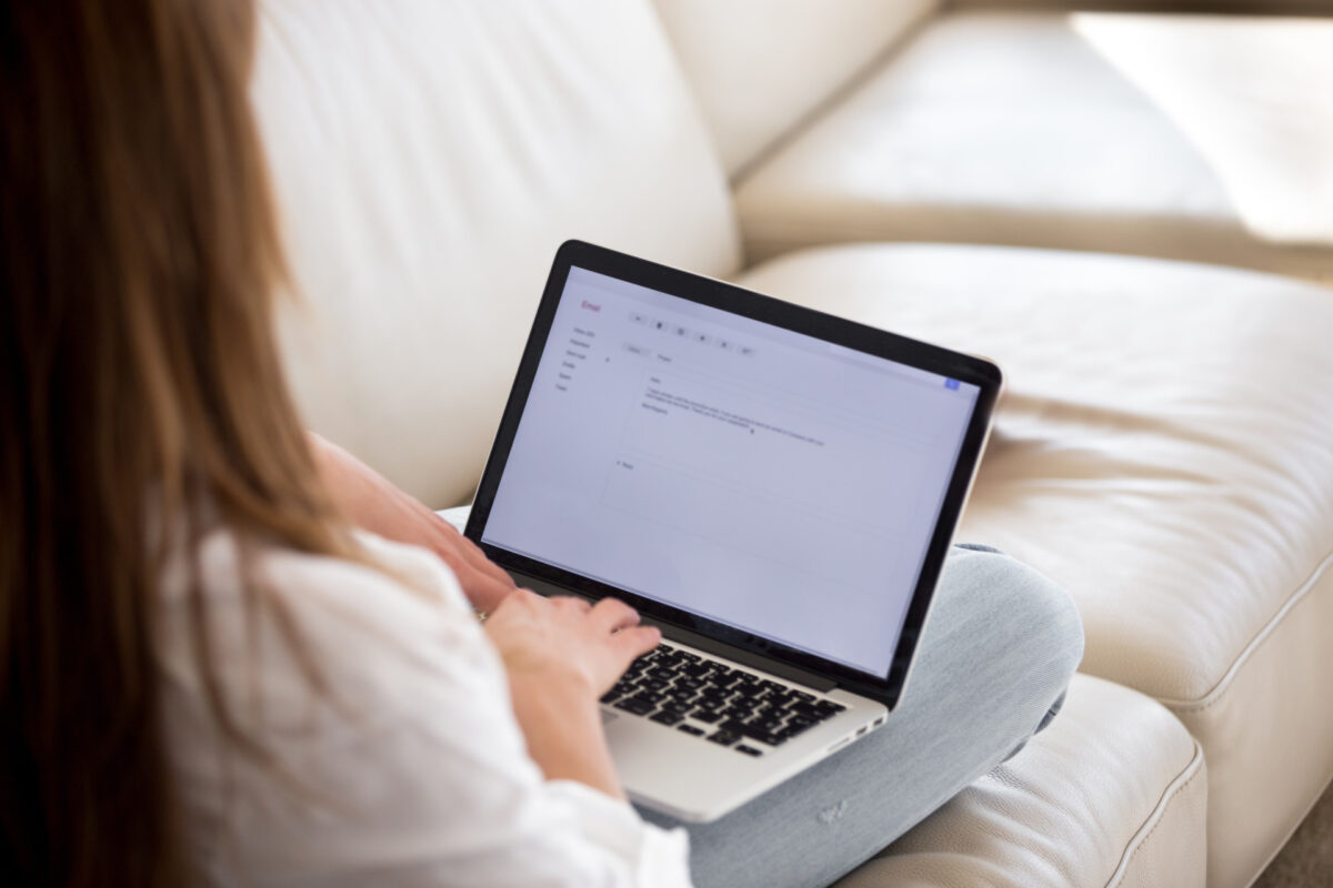 woman typing cover letter on her laptop